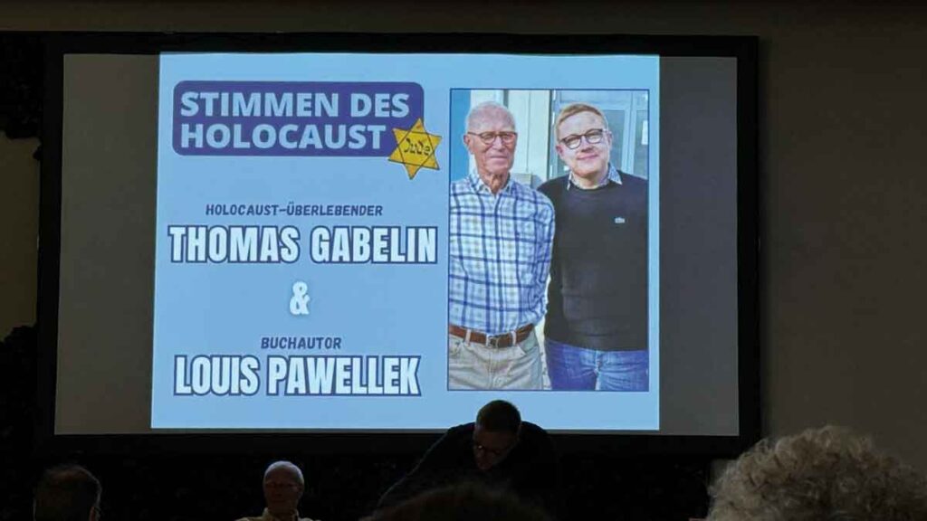 Während des Vortrags wird ein Bild der Vortragenden auf eine Leinwand 1projiziert.